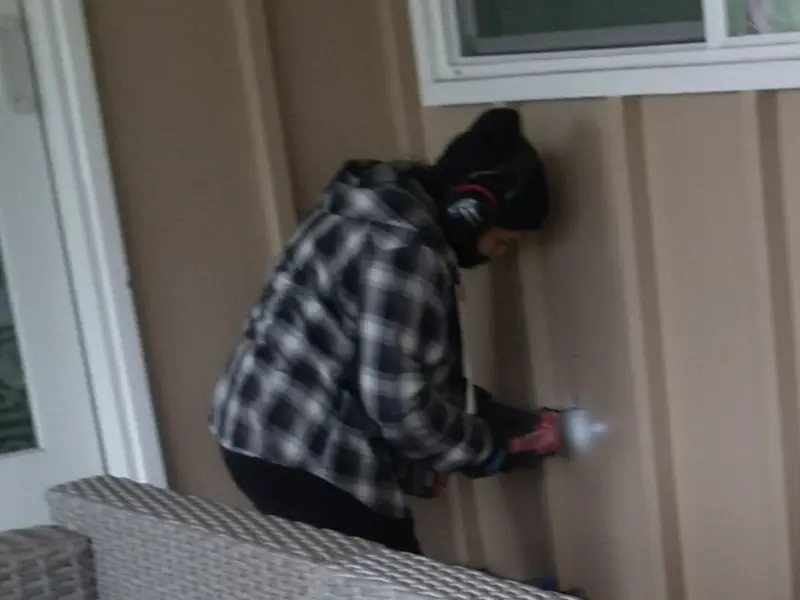 Professional electrician installing an exterior outlet in Aztec