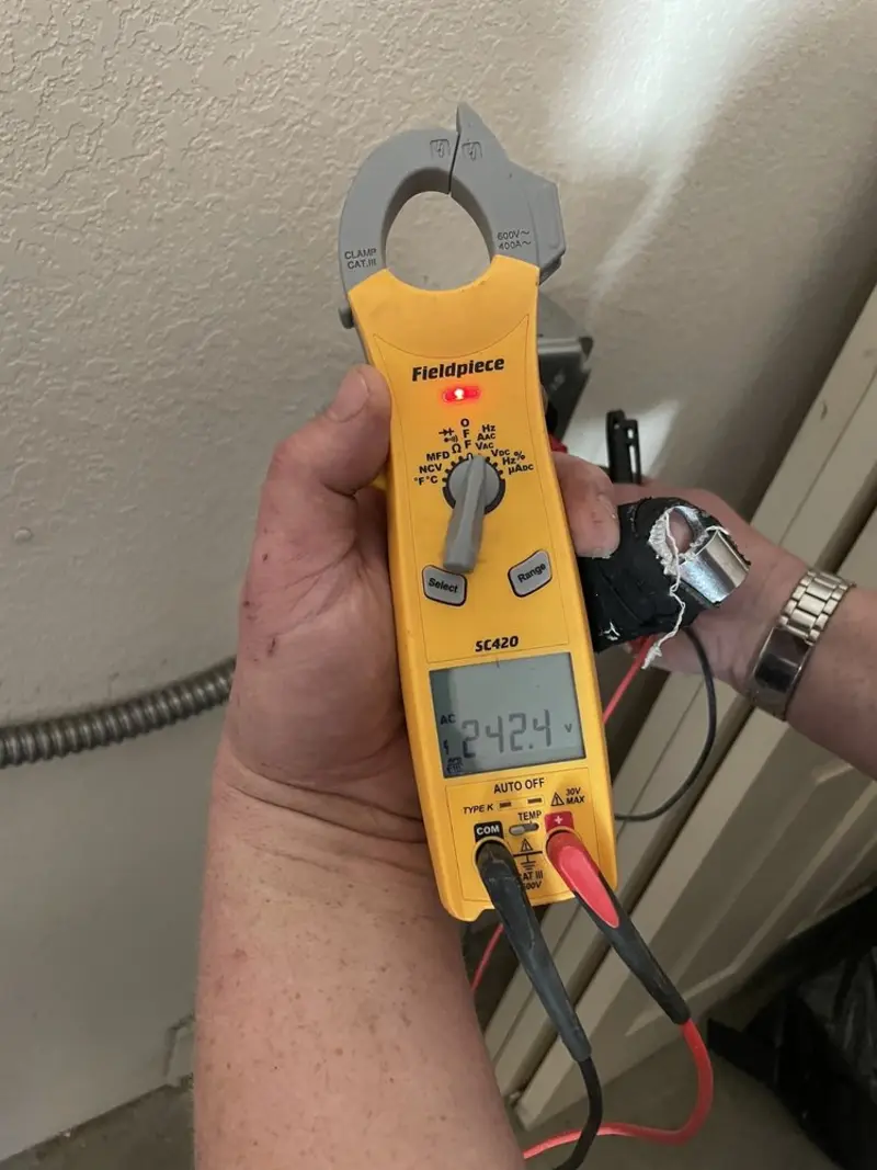 Voltage testing with clamp meter during Outlet Installation in Aztec